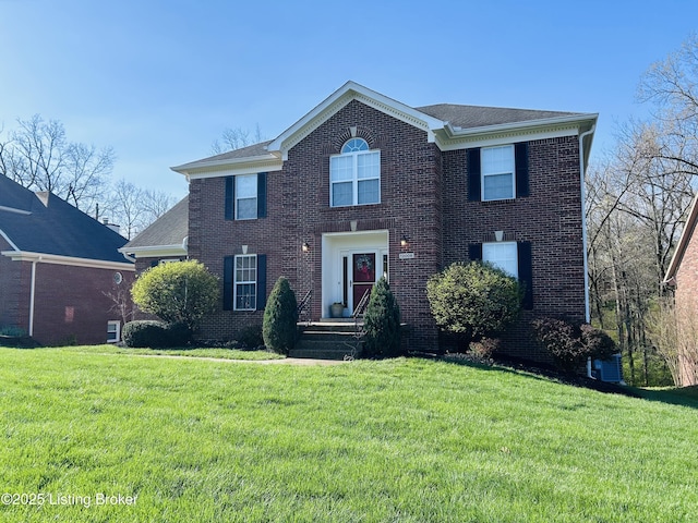 view of front of home with a front yard, brick siding, and a shingled roof