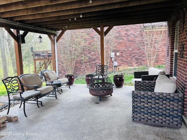 view of patio / terrace with an outdoor fire pit
