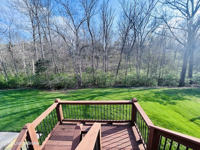 wooden terrace featuring a yard
