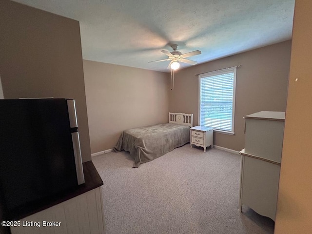 bedroom featuring ceiling fan, baseboards, and carpet