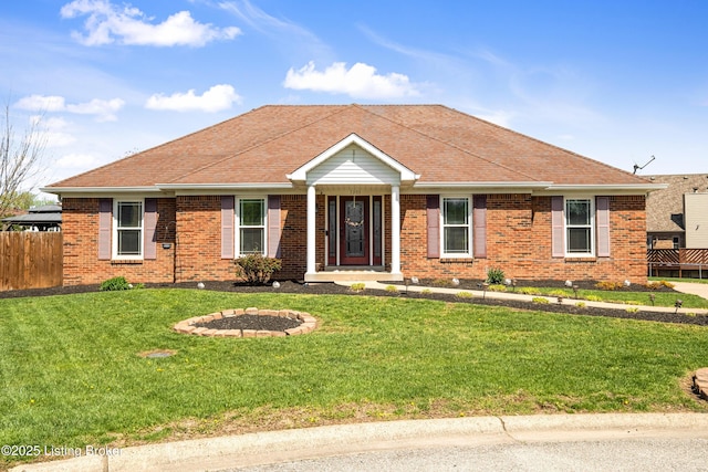 ranch-style house featuring a shingled roof, brick siding, fence, and a front lawn
