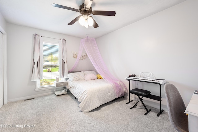 carpeted bedroom featuring visible vents, baseboards, and a ceiling fan