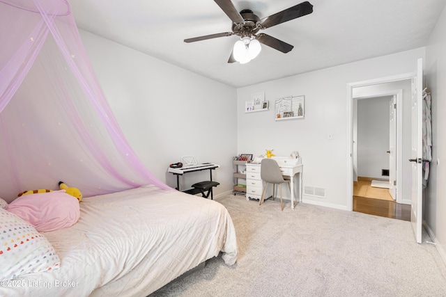 carpeted bedroom featuring visible vents, baseboards, and a ceiling fan
