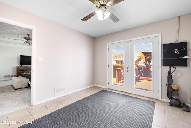 spare room featuring light tile patterned floors, french doors, visible vents, and ceiling fan