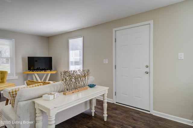 living room with baseboards and dark wood finished floors