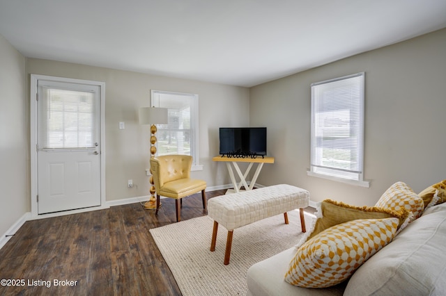 living area with wood finished floors and baseboards