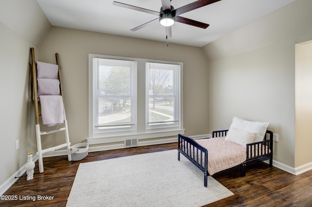 bedroom featuring baseboards, a ceiling fan, visible vents, lofted ceiling, and wood finished floors