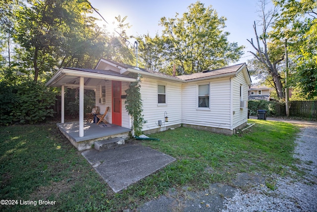 124 E Wellington Ave, Louisville, KY 40214 - rear view of house with a yard, a porch, and fence