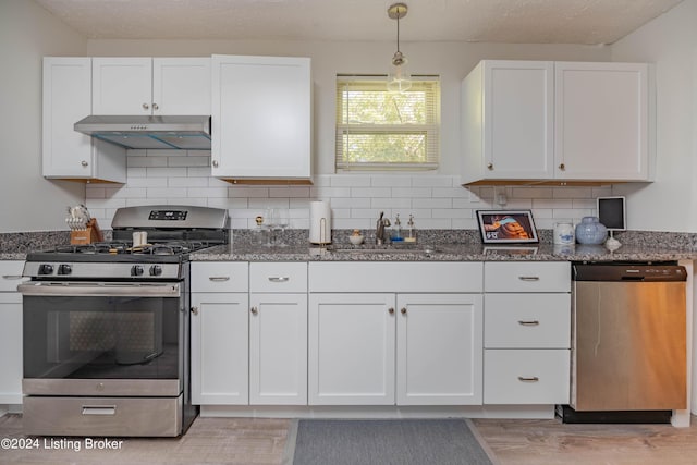 124 E Wellington Ave, Louisville, KY 40214 - kitchen featuring white cabinets, under cabinet range hood, stainless steel appliances, light wood finished floors, and a sink