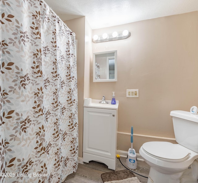 124 E Wellington Ave, Louisville, KY 40214 - bathroom featuring baseboards, a shower with curtain, toilet, a sink, and wood finished floors