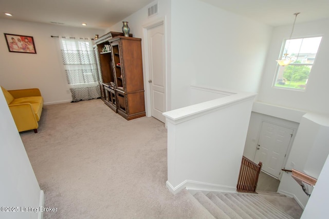 11207 Comfort Ct, Louisville, KY 40229 - hall with healthy amount of natural light, light colored carpet, an upstairs landing, recessed lighting, and baseboards