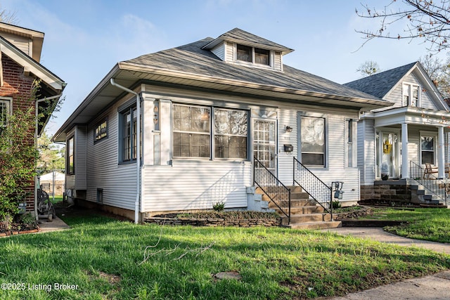 view of front facade with entry steps and a front lawn