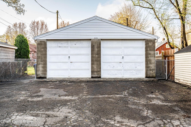 detached garage featuring fence