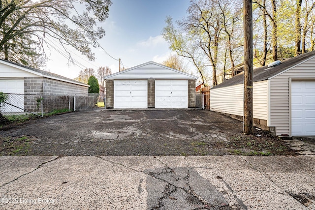 detached garage featuring fence