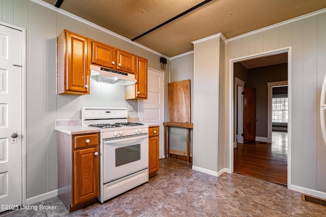 kitchen with brown cabinets, under cabinet range hood, light countertops, and gas range gas stove