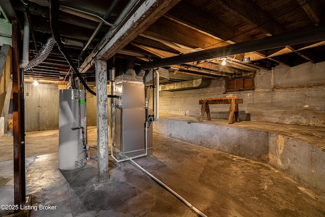unfinished basement featuring gas water heater and heating unit