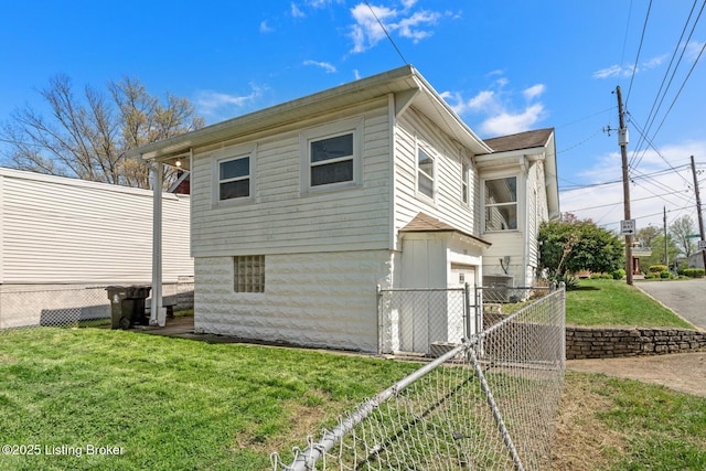 view of home's exterior with a garage, fence, a lawn, and a gate