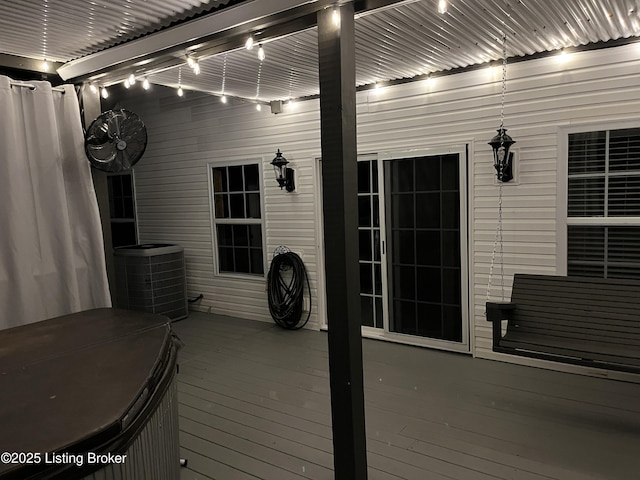 deck featuring central air condition unit and a hot tub