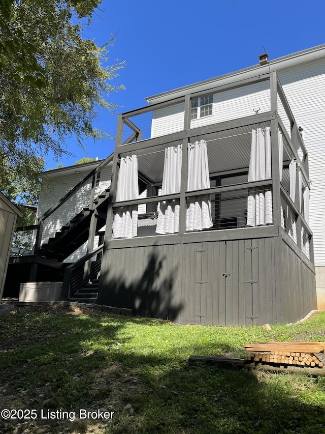 back of house featuring stairway