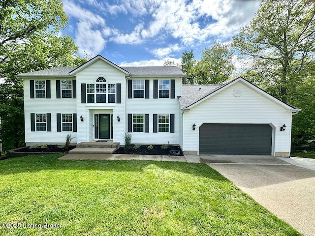 colonial inspired home featuring an attached garage, concrete driveway, and a front lawn
