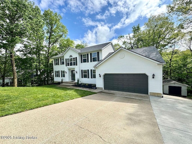 colonial inspired home with a front yard, a garage, and driveway