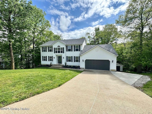 colonial-style house featuring an attached garage, roof with shingles, driveway, and a front lawn