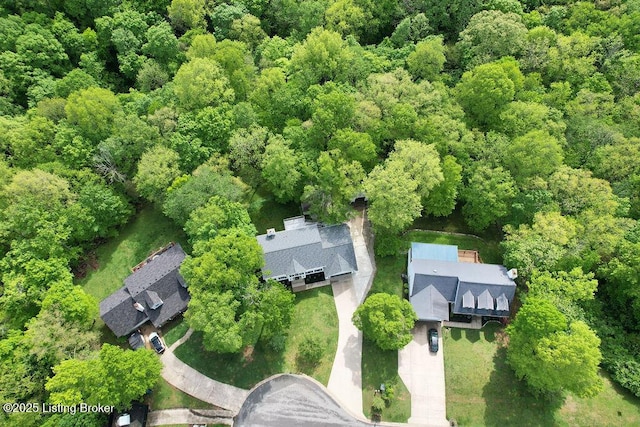 drone / aerial view featuring a forest view
