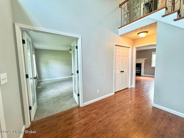 hall featuring baseboards and wood finished floors