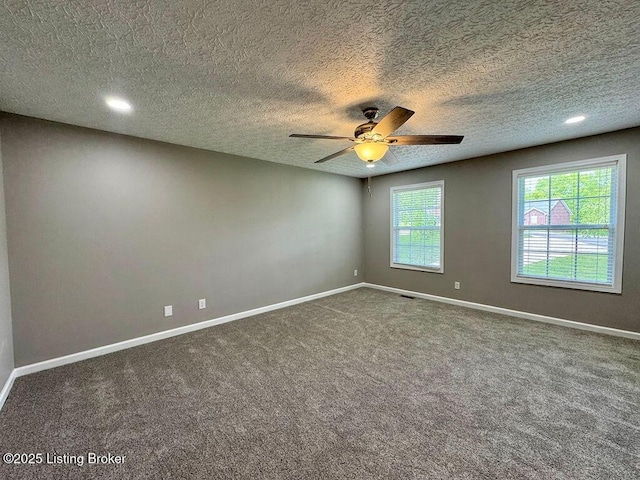 carpeted empty room with a ceiling fan, a textured ceiling, visible vents, baseboards, and recessed lighting