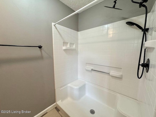full bathroom with a shower and baseboards