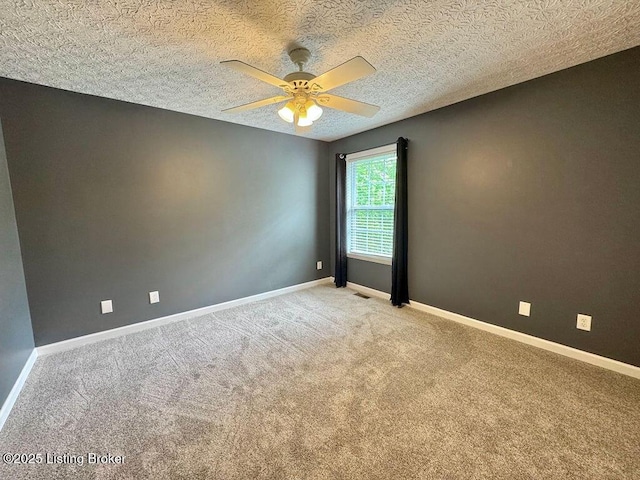 spare room featuring ceiling fan, light carpet, baseboards, and visible vents