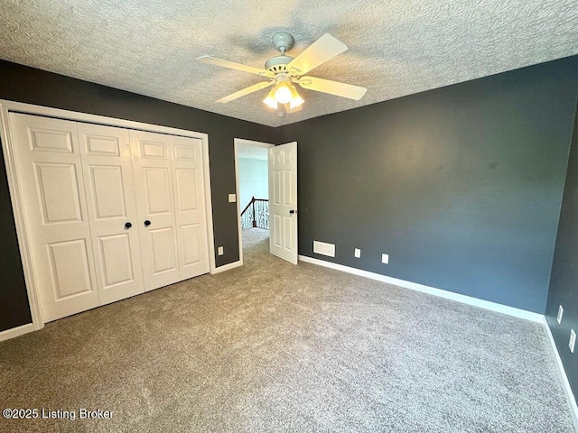 unfurnished bedroom with ceiling fan, carpet floors, baseboards, and a closet