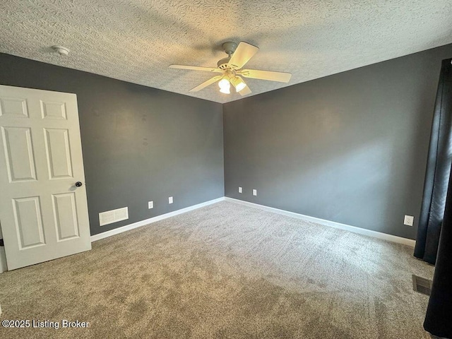 unfurnished room featuring ceiling fan, carpet floors, baseboards, and visible vents