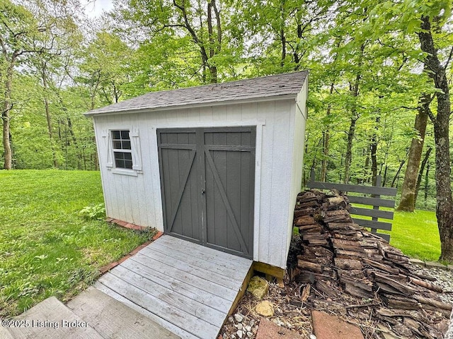 view of shed with a wooded view