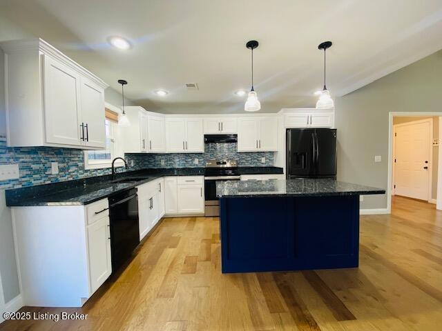 kitchen featuring white cabinets, a center island, a sink, light wood-type flooring, and black appliances