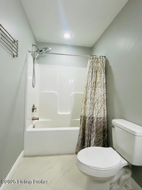 full bathroom with toilet, baseboards, and shower / bath combination with curtain