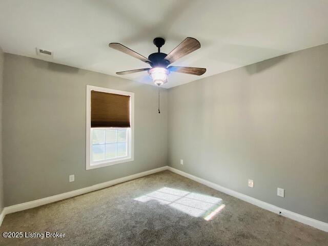 empty room featuring ceiling fan, baseboards, carpet flooring, and visible vents