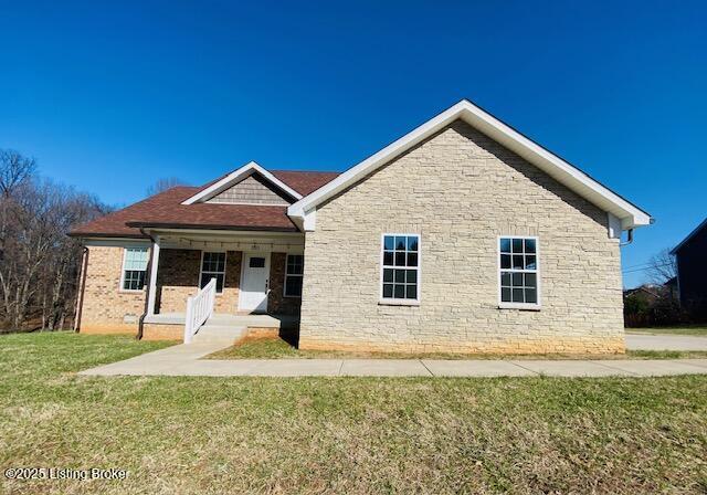 view of front of home with a porch and a front lawn