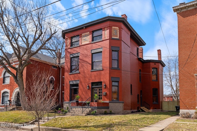 1026 S Brook St, Louisville, KY 40203 - view of front of home with a front yard, fence, brick siding, and a chimney