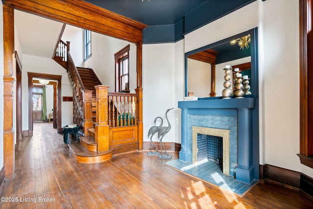 1026 S Brook St, Louisville, KY 40203 - living area with baseboards, a fireplace, hardwood / wood-style flooring, and stairs