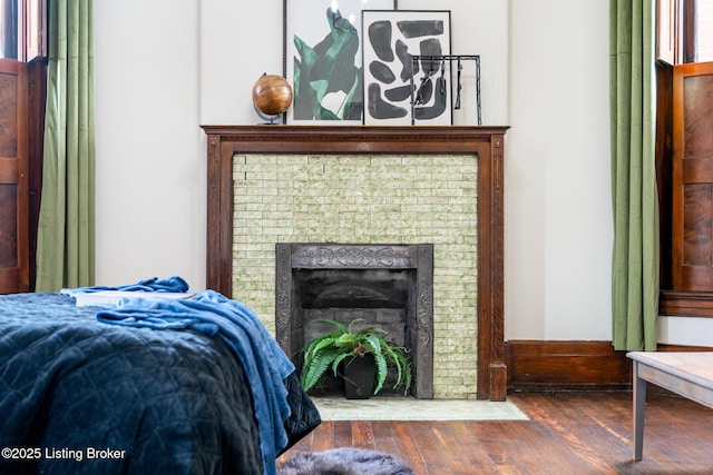 1026 S Brook St, Louisville, KY 40203 - bedroom with wood finished floors and a fireplace