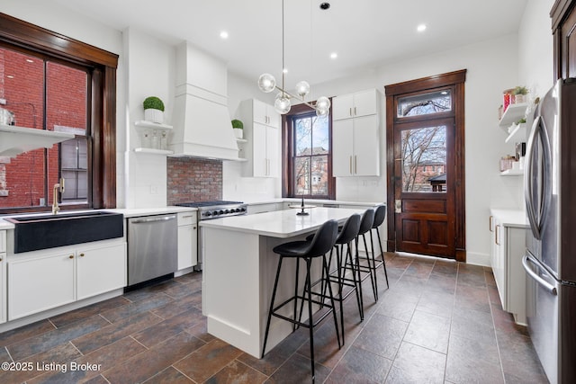 1026 S Brook St, Louisville, KY 40203 - kitchen with open shelves, a sink, light countertops, premium range hood, and stainless steel appliances