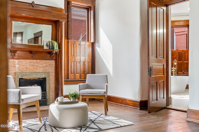 1026 S Brook St, Louisville, KY 40203 - sitting room with a tiled fireplace, baseboards, and hardwood / wood-style floors