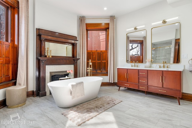 1026 S Brook St, Louisville, KY 40203 - bathroom with a sink, a soaking tub, a fireplace, a shower stall, and double vanity