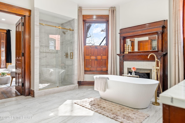 1026 S Brook St, Louisville, KY 40203 - bathroom featuring a shower stall, a fireplace, baseboards, and a freestanding tub