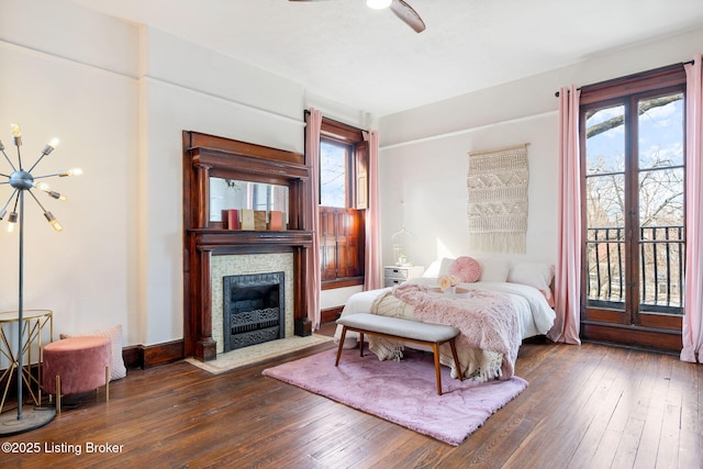 1026 S Brook St, Louisville, KY 40203 - bedroom featuring a chandelier, a fireplace with flush hearth, multiple windows, and hardwood / wood-style flooring