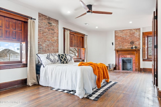 1026 S Brook St, Louisville, KY 40203 - bedroom with visible vents, baseboards, a brick fireplace, recessed lighting, and hardwood / wood-style floors
