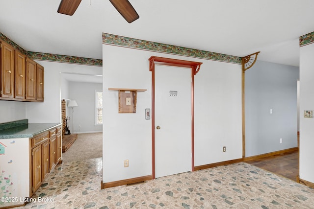 interior space featuring baseboards and a ceiling fan