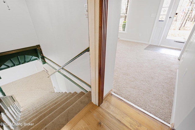 stairway with carpet flooring and baseboards
