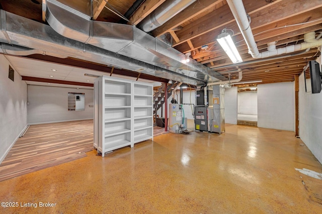 unfinished basement featuring heating unit and water heater